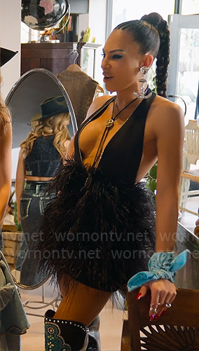 Amanza’s black feather mini dress, embellished boots and Chanel bus bag on Selling Sunset