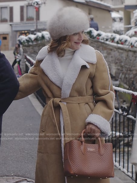 Louis’s suede shearling coat and brown leather bag on Emily in Paris