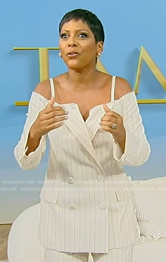 Tamron’s white pinstripe cold shoulder blazer on Tamron Hall Show