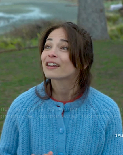 Cassandra’s blue knit cardigan on Murder in a Small Town