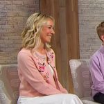 Hilary Levine’s pink floral embroidered cardigan on Sherri