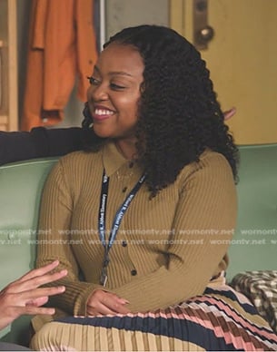 Janine’s camel ribbed knit shirt and striped pleated skirt on Abbott Elementary