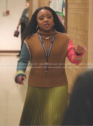 Janine’s brown colorblock ribbed sweater and yellow pleated skirt on Abbott Elementary