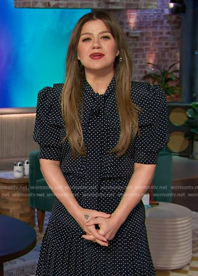 Kelly’s navy polka dot print tie neck dress on The Kelly Clarkson Show
