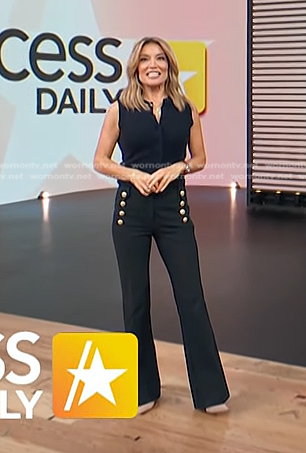 kit’s navy knit top and black pants with gold buttons on Access Hollywood