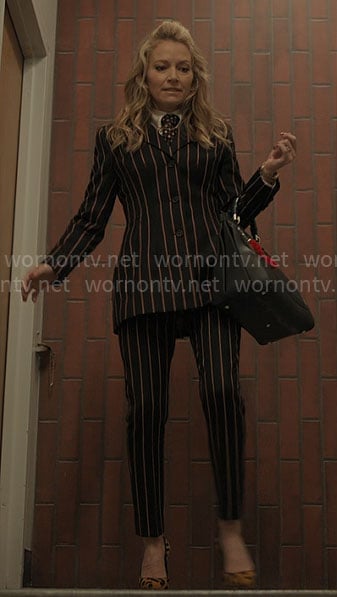 Lorna’s striped suit, leopard pumps, and leather bag on The Lincoln Lawyer