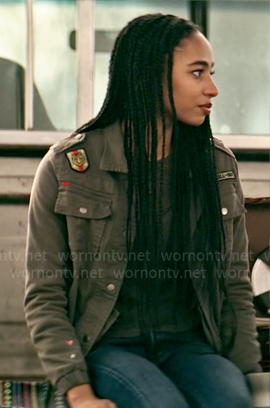 Natalie’s grey jacket with patches on Superman and Lois
