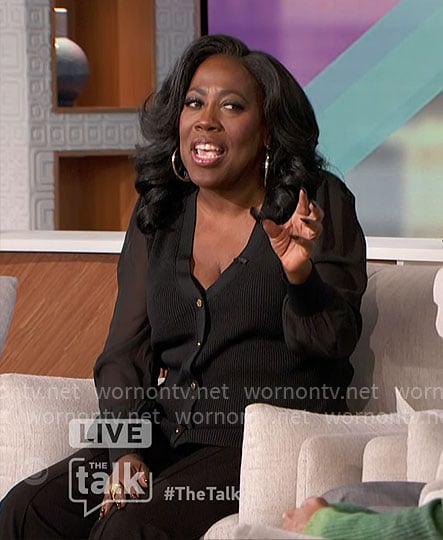 Sheryl’s black v-neck cardigan with sheer sleeves on The Talk