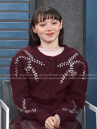 Violet McGraw’s burgundy embroidered cardigan and leather skirt on Access Hollywood