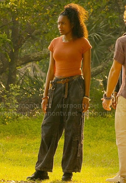 Cleo’s orange tee and black cargo jeans on Outer Banks
