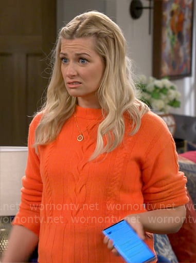 Gemma’s orange cable-knit sweater on The Neighborhood