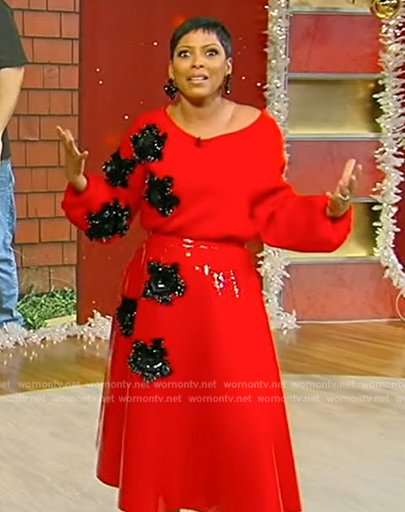 Tamron’s red floral embellished sweater and skirt on Tamron Hall Show