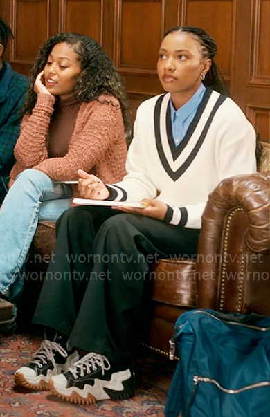 Whitney’s white v-neck sweater with striped trim on The Sex Lives of College Girls