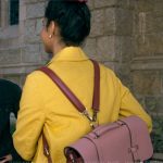 Bela’s pink colorblock backpack on The Sex Lives of College Girls