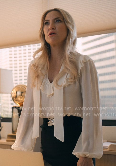 Isla’s white ruffled tie-neck blouse on Running Point