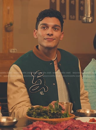 Q’s green varsity jacket with patch on XO Kitty