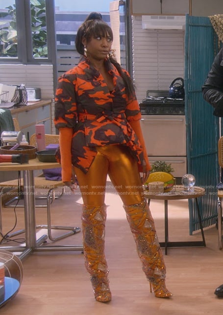 Tasha’s orange printed asymmetric top and boots on The Upshaws