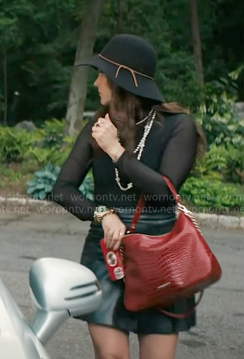 Birdie’s black top, leather skirt and red bag on Grosse Pointe Garden Society