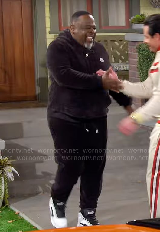 Calvin’s black velour track suit on The Neighborhood