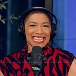 Deja Vu’s red printed mock neck top on Live with Kelly and Mark