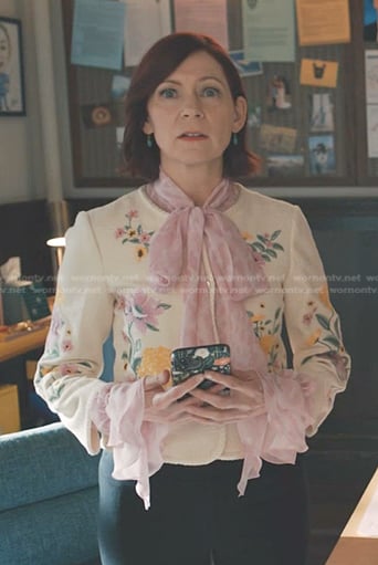 Elsbeth’s print tie neck blouse and white floral jacket on Elsbeth