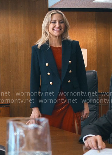 Isla’s navy blazer with gold buttons on Running Point