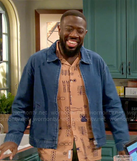 Malcolm’s orange printed shirt and denim jacket on The Neighborhood