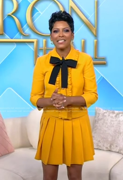 Tamron’s yellow tie neck top and skirt on Tamron Hall Show