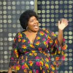 Dulcé Sloan’s black floral print wrap dress on Tamron Hall Show