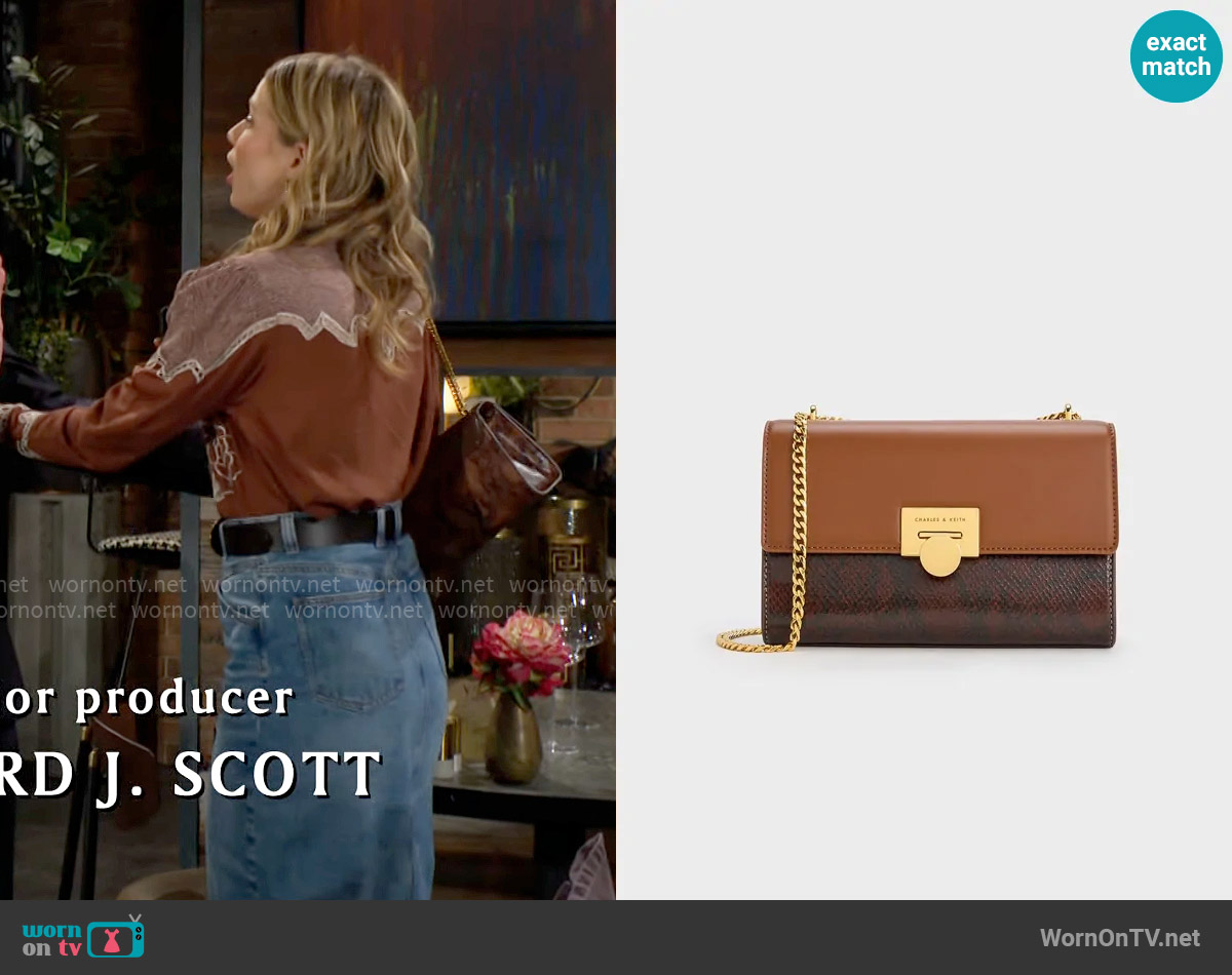 Charles & Keith Snake Print Chain-Strap Bag in Chocolate worn by Summer Newman (Allison Lanier) on The Young and the Restless