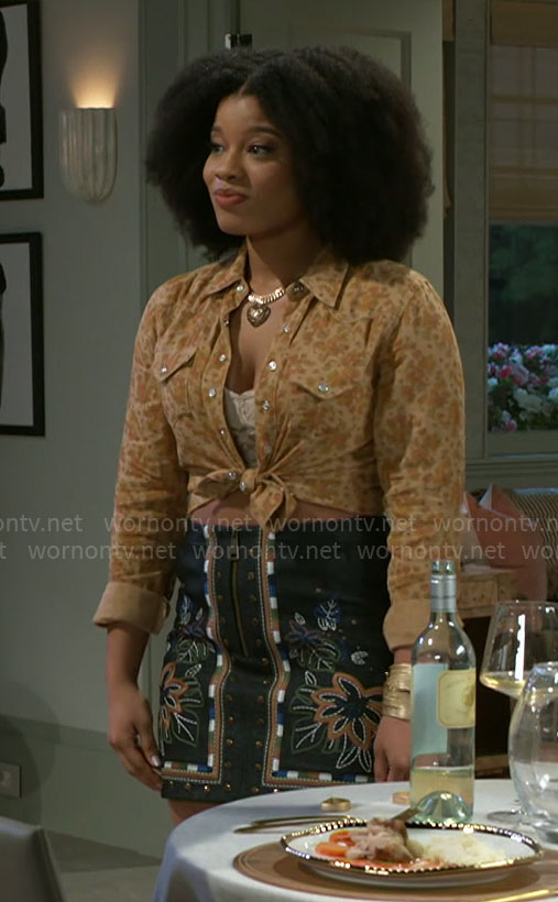 Eva’s yellow floral button down shirt and embroidered mini skirt on Beyond the Gates
