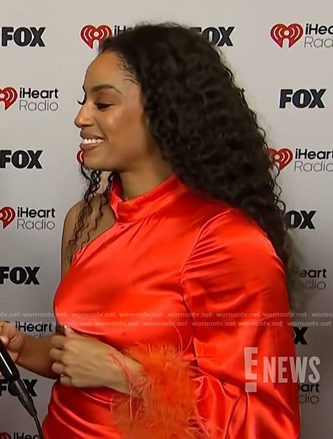 Francesca Amiker’s red satin feather trim dress on E! News