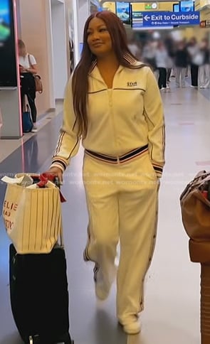 Garcelle’s white stripe track jacket and pants on The Real Housewives of Beverly Hills