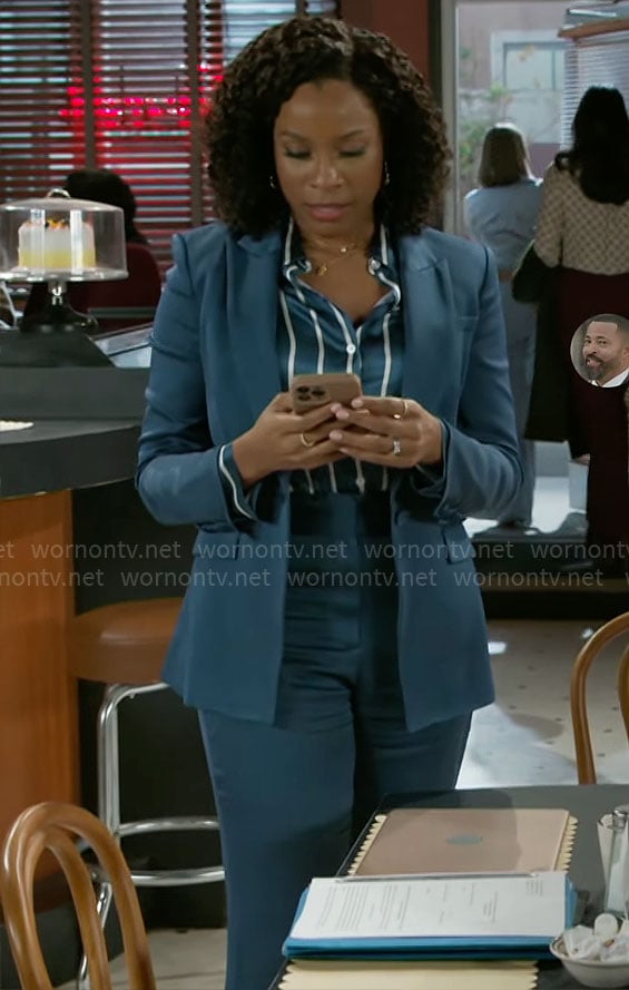 Naomi’s teal blue suit and striped button down blouse on Beyond the Gates