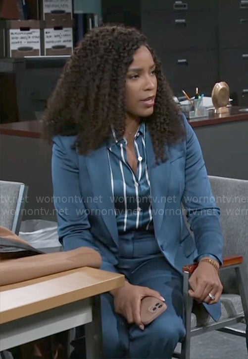 Naomi’s teal blue suit and striped button down blouse on Beyond the Gates