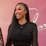 Tamar’s black sheer logo top and skirt on Sherri