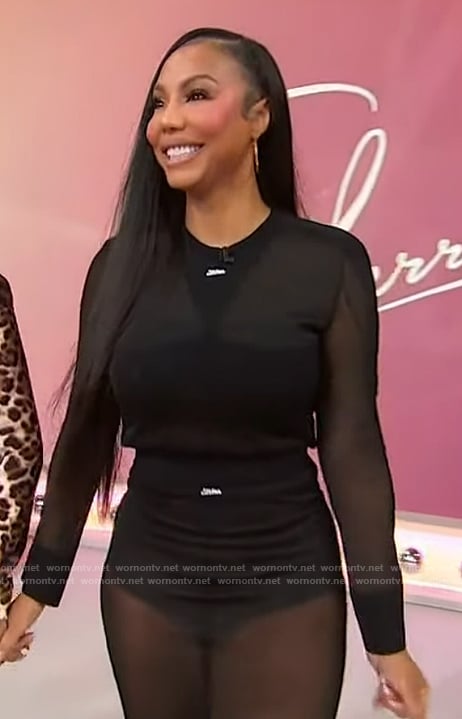 Tamar’s black sheer logo top and skirt on Sherri