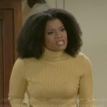 Eva’s yellow sweater and fringed wrap skirt on Beyond the Gates