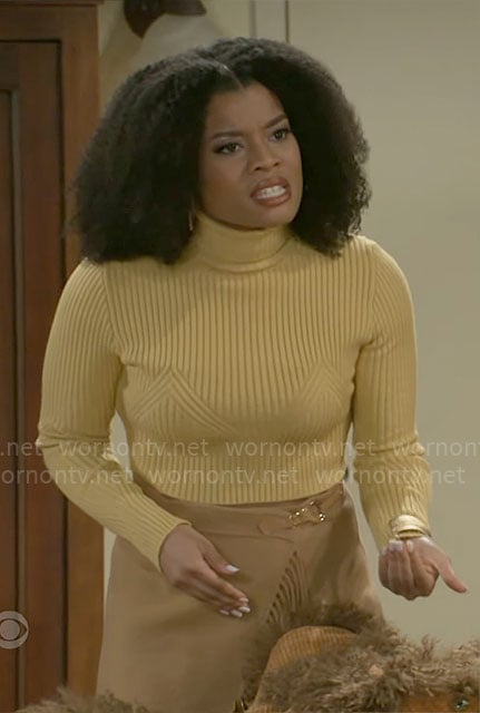 Eva’s yellow sweater and fringed wrap skirt on Beyond the Gates
