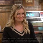 Gemma’s black v-neck sweater with striped trim on The Neighborhood