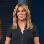 Kit’s black polo shirt and pants on Access Hollywood