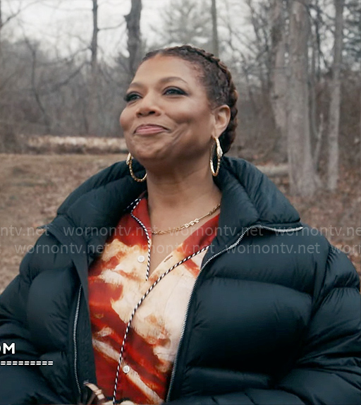 Robyn’s painted print shirt and pants set with black coat on The Equalizer