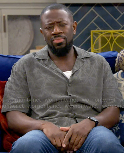 Malcolm’s khaki green triangle shirt on The Neighborhood