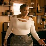 Robyn’s white cutout shoulder sweater and monogram print pants on The Equalizer