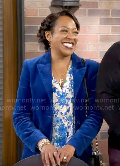 Tina’s blue velvet suit and floral blouse on The Neighborhood