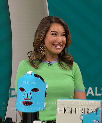 Courtney Cason’s green short-sleeve sweater with blue trims on CBS Mornings