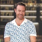 Paul Zahn’s blue geometric print polo on Access Hollywood