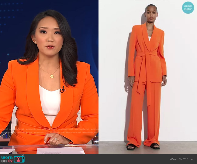 Zara Belted Tuxedo Collar Blazer in Orange worn by Nancy Chen on CBS Evening News