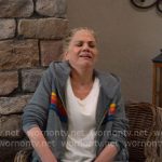 Carol’s grey hoodie with rainbow stripes and navy track pants on Leanne