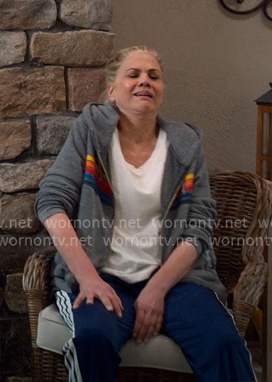 Carol’s grey hoodie with rainbow stripes and navy track pants on Leanne